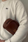 Toiletry bag with brown handle